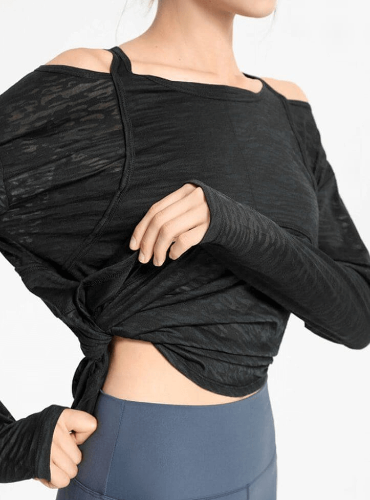 Sporty lightweight women’s top with long sleeves and cutouts, perfect for yoga, shown in black with stylish design. SF1188.